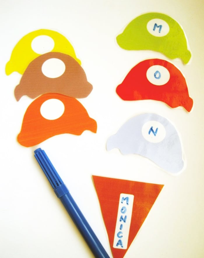 Image shows an ice cream cone in brown with a name and scoops of ice cream with letters for name building in orange, yellow, white, brown, and red from Tot Schooling.